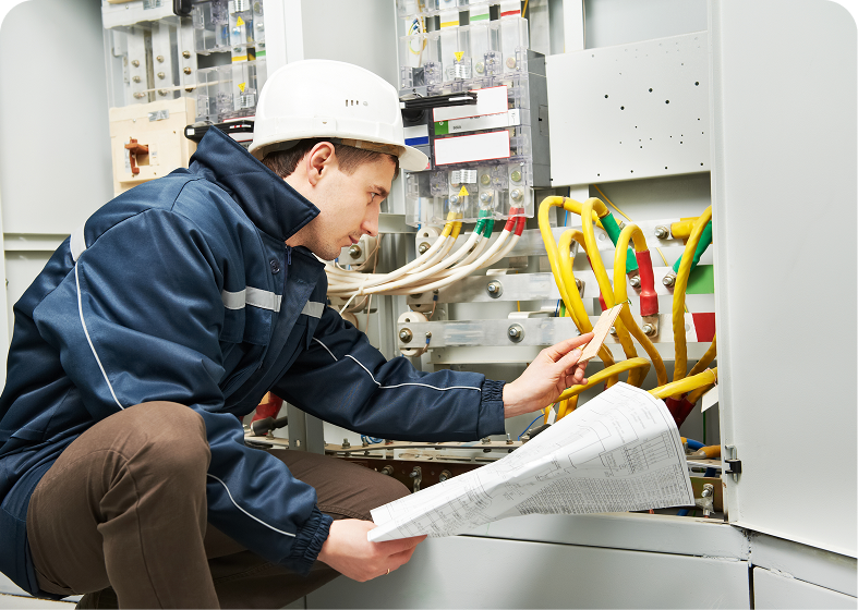 Technician analyzing wiring inside control cabinet