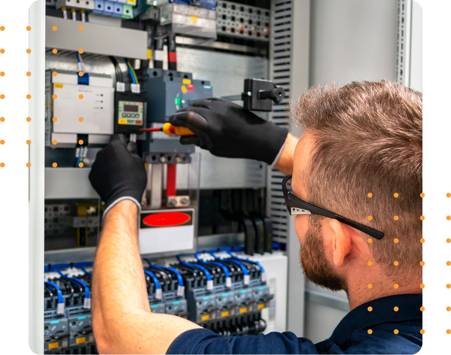 Man servicing electrical control panel