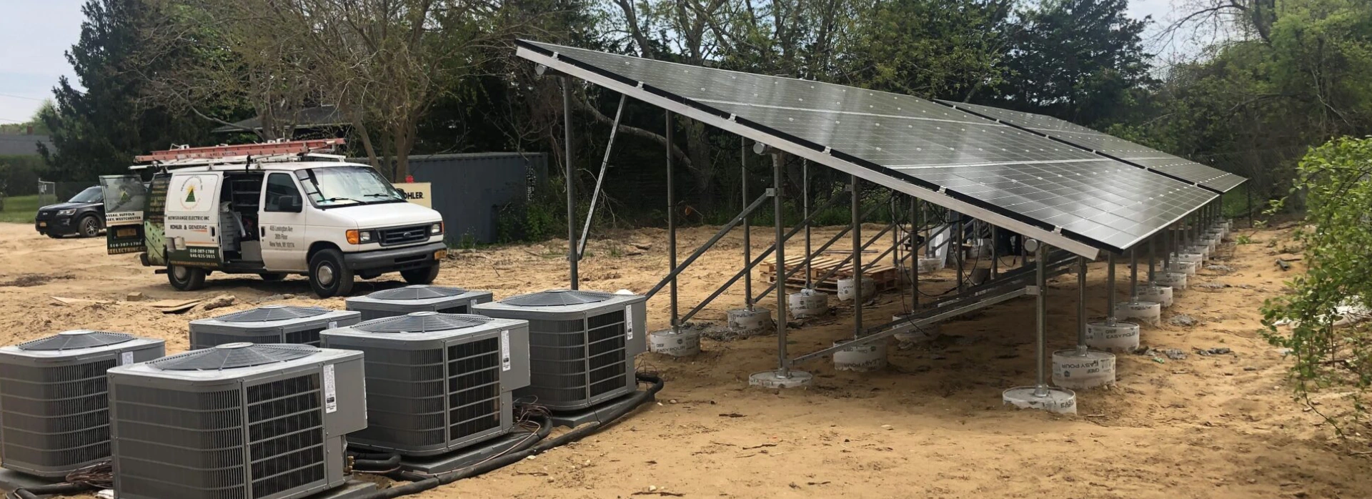 Solar panels installed outdoors with air conditioning units nearby.